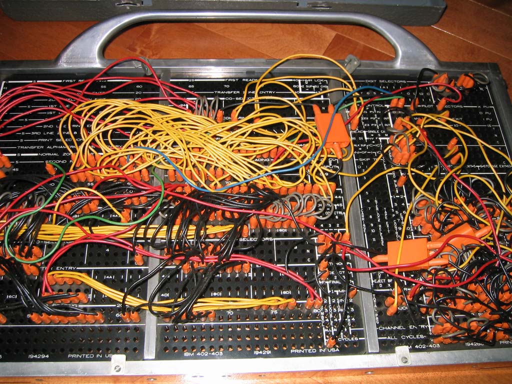 An IBM 402 accounting machine plugboard showing a tangle of wires connecting terminals to encode program logic